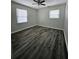 A bedroom showcasing new hardwood flooring, two windows, and modern paint at 6658 Collins Ct, Riverdale, GA 30274