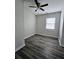 Bedroom with new hardwood floors, ceiling fan, and modern paint at 6658 Collins Ct, Riverdale, GA 30274