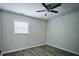 Bedroom featuring a ceiling fan, window, and hardwood style flooring at 6658 Collins Ct, Riverdale, GA 30274