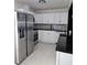 Kitchen has stainless steel appliances, white cabinets, and plenty of counter space at 6658 Collins Ct, Riverdale, GA 30274