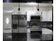 Bright modern kitchen featuring stainless appliances, granite countertops and open breakfast bar at 6658 Collins Ct, Riverdale, GA 30274