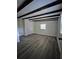 Spacious living room with dark wood beam ceilings and modern gray wood flooring at 6658 Collins Ct, Riverdale, GA 30274