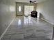 Bright living room features tile floors, a ceiling fan, and a front door that lets in natural light at 6658 Collins Ct, Riverdale, GA 30274