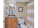 Bathroom with granite countertop vanity and shower with striped curtain at 1280 W Peachtree Nw St # 2302, Atlanta, GA 30309