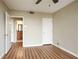 Bedroom with neutral walls, ceiling fan, wood-look flooring, and ensuite bathroom access at 1280 W Peachtree Nw St # 2302, Atlanta, GA 30309