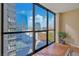 Bright living room with large windows providing panoramic city views and hardwood floors at 1280 W Peachtree Nw St # 2302, Atlanta, GA 30309