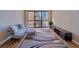 Bright living room featuring a large window with city views, modern furniture and hardwood floors at 1280 W Peachtree Nw St # 2302, Atlanta, GA 30309