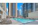 Rooftop pool surrounded by skyscrapers and lounge chairs on a sunny day at 1280 W Peachtree Nw St # 2302, Atlanta, GA 30309