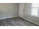 Inviting bedroom featuring attractive gray wood-look flooring and ample natural light at 159 Cedar Ridge Trl, Lawrenceville, GA 30046