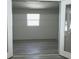 A living room area showcasing the window and grey wood floors at 159 Cedar Ridge Trl, Lawrenceville, GA 30046