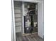 Utility closet contains a water heater, HVAC system, shelving and updated flooring at 159 Cedar Ridge Trl, Lawrenceville, GA 30046