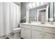 Well-lit bathroom featuring a double vanity, shower-tub combo, and neutral-toned walls at 2540 River Summit Dr, Duluth, GA 30097