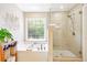 Serene bathroom featuring a soaking tub under a window and a separate glass-enclosed shower at 2540 River Summit Dr, Duluth, GA 30097