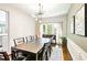 Dining room with a dark wood table, modern light fixture, and decorative wainscoting at 2540 River Summit Dr, Duluth, GA 30097