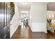 Hallway with hardwood floors, white wainscoting, and view into dining and kitchen areas at 2540 River Summit Dr, Duluth, GA 30097