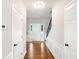 Hallway featuring hardwood floors, wainscoting, and view of front door and staircase at 2540 River Summit Dr, Duluth, GA 30097