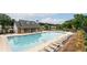 Community pool with lounge chairs and seating overlooking a lake at 2540 River Summit Dr, Duluth, GA 30097