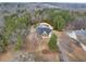 Aerial view of home surrounded by trees, complete with front yard and backyard including in-ground pool at 2915 Pruitt Rd, Cumming, GA 30041