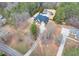 High angle view of a property featuring a home with an in-ground pool, surrounded by lush trees and greenery at 2915 Pruitt Rd, Cumming, GA 30041