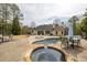 Relaxing backyard setup with outdoor seating area around the in-ground pool and spa at 2915 Pruitt Rd, Cumming, GA 30041
