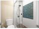 Beautifully tiled shower with glass door, pebble floor, and decorative tile accents in this bathroom at 2915 Pruitt Rd, Cumming, GA 30041