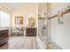 Bright bathroom with a glass-enclosed shower, stylish wood-look floors, and modern fixtures at 2915 Pruitt Rd, Cumming, GA 30041
