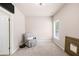 Inviting bedroom with neutral walls, a gray recliner, and ample natural light at 2915 Pruitt Rd, Cumming, GA 30041