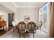 Elegant dining room with large windows, stylish chairs, and beautiful chandelier at 2915 Pruitt Rd, Cumming, GA 30041