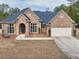 Charming brick home with a well-manicured lawn and a two-car garage at 2915 Pruitt Rd, Cumming, GA 30041