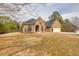 Charming brick home featuring an attached two car garage and a well manicured front lawn and garden at 2915 Pruitt Rd, Cumming, GA 30041