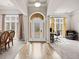 Grand foyer with soaring ceilings, hardwood floors, and elegant lighting fixtures at 2915 Pruitt Rd, Cumming, GA 30041
