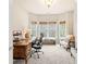 Inviting home office with bright bay windows, plush carpet, and classic wooden desk at 2915 Pruitt Rd, Cumming, GA 30041