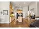 Well-lit kitchen featuring a central island, black appliances, and wood flooring at 2915 Pruitt Rd, Cumming, GA 30041