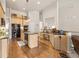 Bright open-concept kitchen with hardwood floors, island, granite countertops, and modern lighting at 2915 Pruitt Rd, Cumming, GA 30041