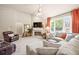 Bright living room with a fireplace, TV, and comfortable sectional sofa, flooded with natural light at 2915 Pruitt Rd, Cumming, GA 30041