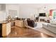 Open-concept living space with hardwood floors, fireplace, and abundant natural light at 2915 Pruitt Rd, Cumming, GA 30041