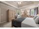 Main bedroom with tray ceiling, walk-out door to patio, and en suite bathroom at 2915 Pruitt Rd, Cumming, GA 30041