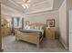 Spacious main bedroom with tray ceiling, carpet flooring, and large windows overlooking yard at 2915 Pruitt Rd, Cumming, GA 30041