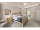 Well-lit main bedroom with carpet flooring, tray ceilings, a ceiling fan, and en suite bathroom at 2915 Pruitt Rd, Cumming, GA 30041