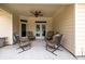 Covered patio with ceiling fan, seating, and access to the backyard, ideal for relaxation at 2915 Pruitt Rd, Cumming, GA 30041