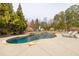 Serene in-ground pool surrounded by mature trees and landscaping, perfect for outdoor enjoyment at 2915 Pruitt Rd, Cumming, GA 30041