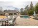 Backyard pool with waterfall feature and plenty of patio space for entertaining at 2915 Pruitt Rd, Cumming, GA 30041