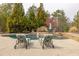 Beautiful in-ground pool with chairs and lovely waterfall feature surrounded by mature trees at 2915 Pruitt Rd, Cumming, GA 30041