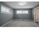 A gray bedroom showcases a kitchen entrance, complementing its two light-filled windows at 3449 Hyland Dr, Decatur, GA 30032