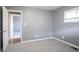 This bedroom has gray walls, neutral carpeting, and a door leading to another room at 3449 Hyland Dr, Decatur, GA 30032