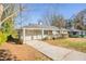 Charming one-story home featuring a covered entrance, grey paint, and a well-maintained front yard at 3449 Hyland Dr, Decatur, GA 30032