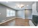 Bright living room featuring a grey brick fireplace, hardwood floors, and natural light at 3449 Hyland Dr, Decatur, GA 30032