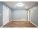 Bright living room featuring light grey paint, hardwood floors, and two entry doors at 3449 Hyland Dr, Decatur, GA 30032