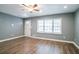 Bright living room featuring light grey paint, hardwood floors, and natural light from a large window at 3449 Hyland Dr, Decatur, GA 30032