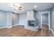 Bright living room featuring a grey brick fireplace, hardwood floors, and natural light at 3449 Hyland Dr, Decatur, GA 30032